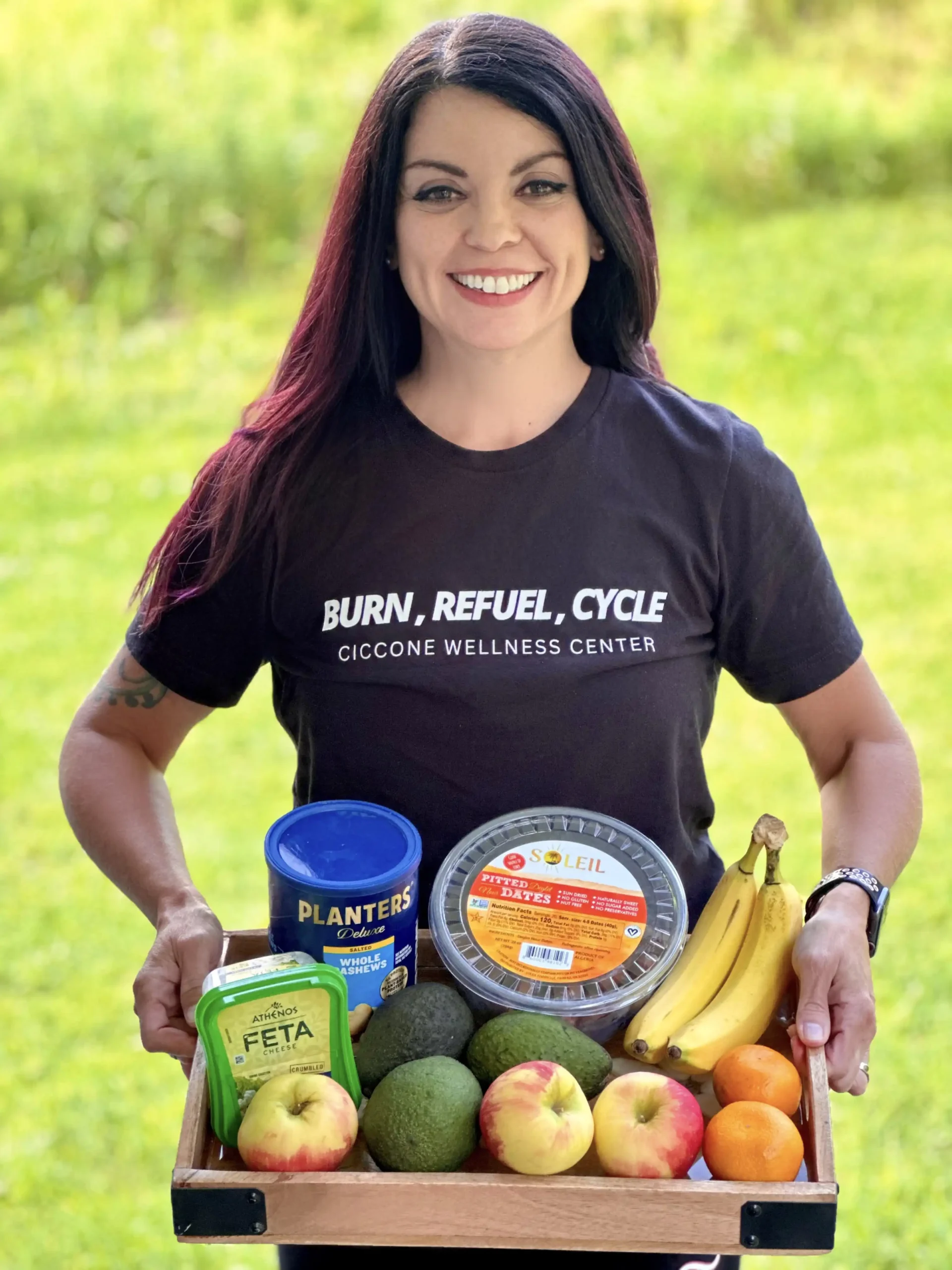 a Ciccone Wellness grad holding a tray of healthy food